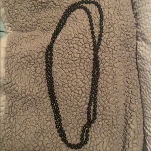 Very long black bead necklace bought from boutique